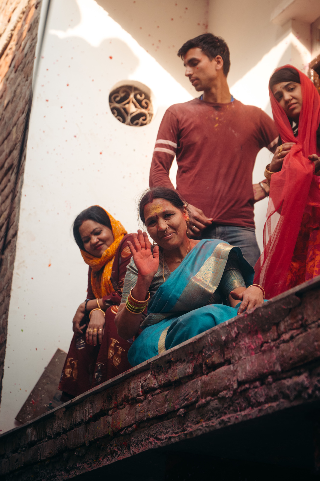 a group of people standing on top of a brick wall