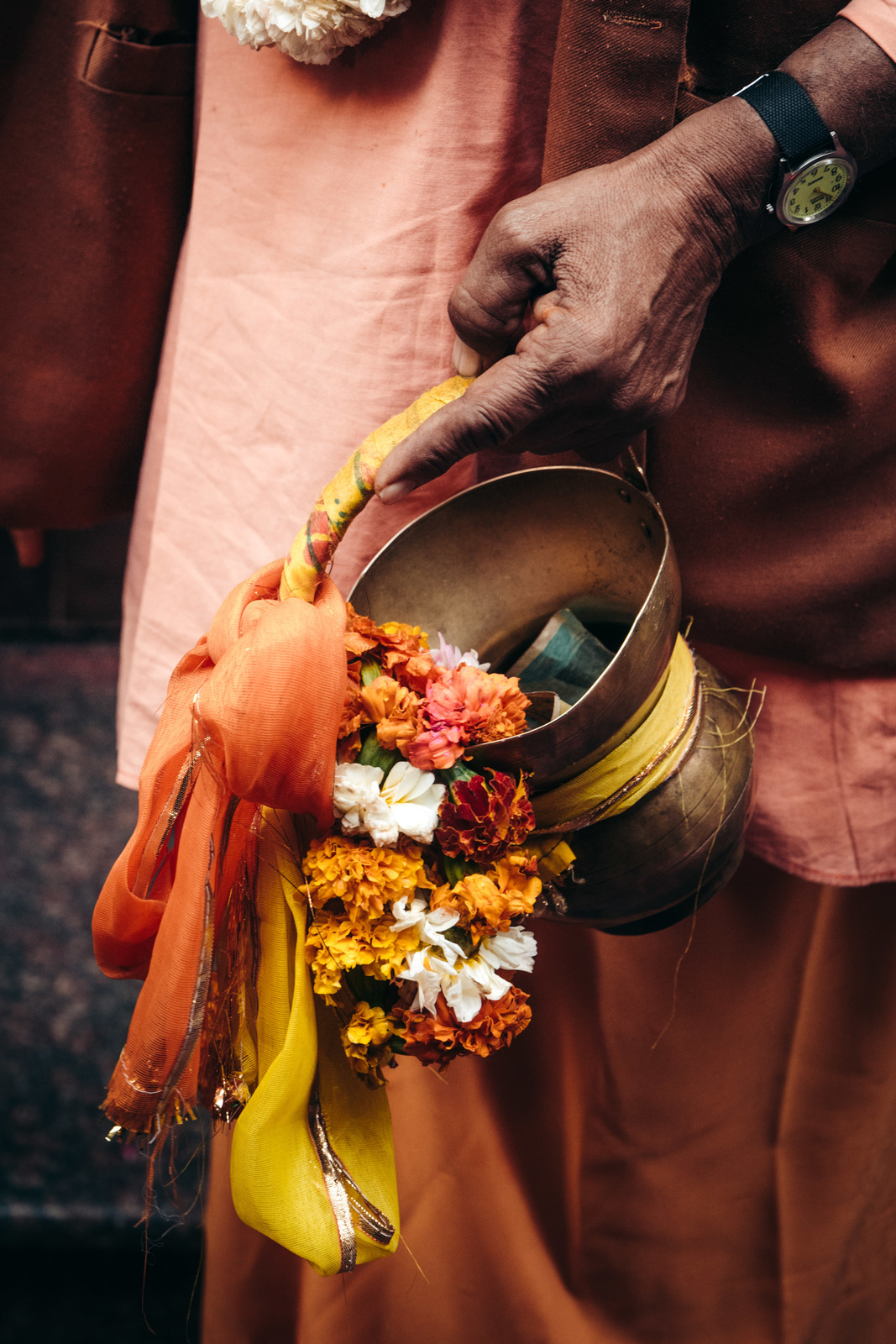 a man is holding a bucket full of flowers