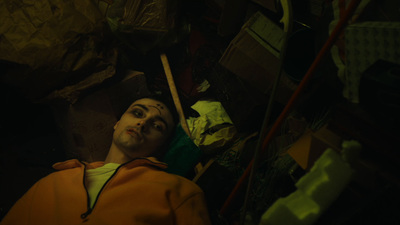 a man laying down in a pile of junk