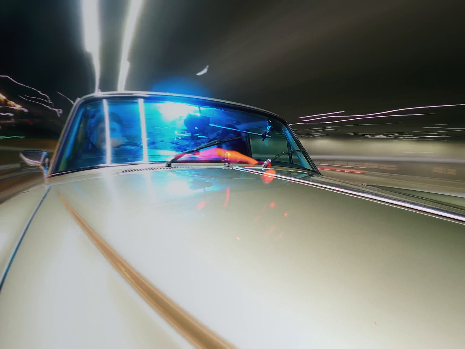 a car driving down a street at night