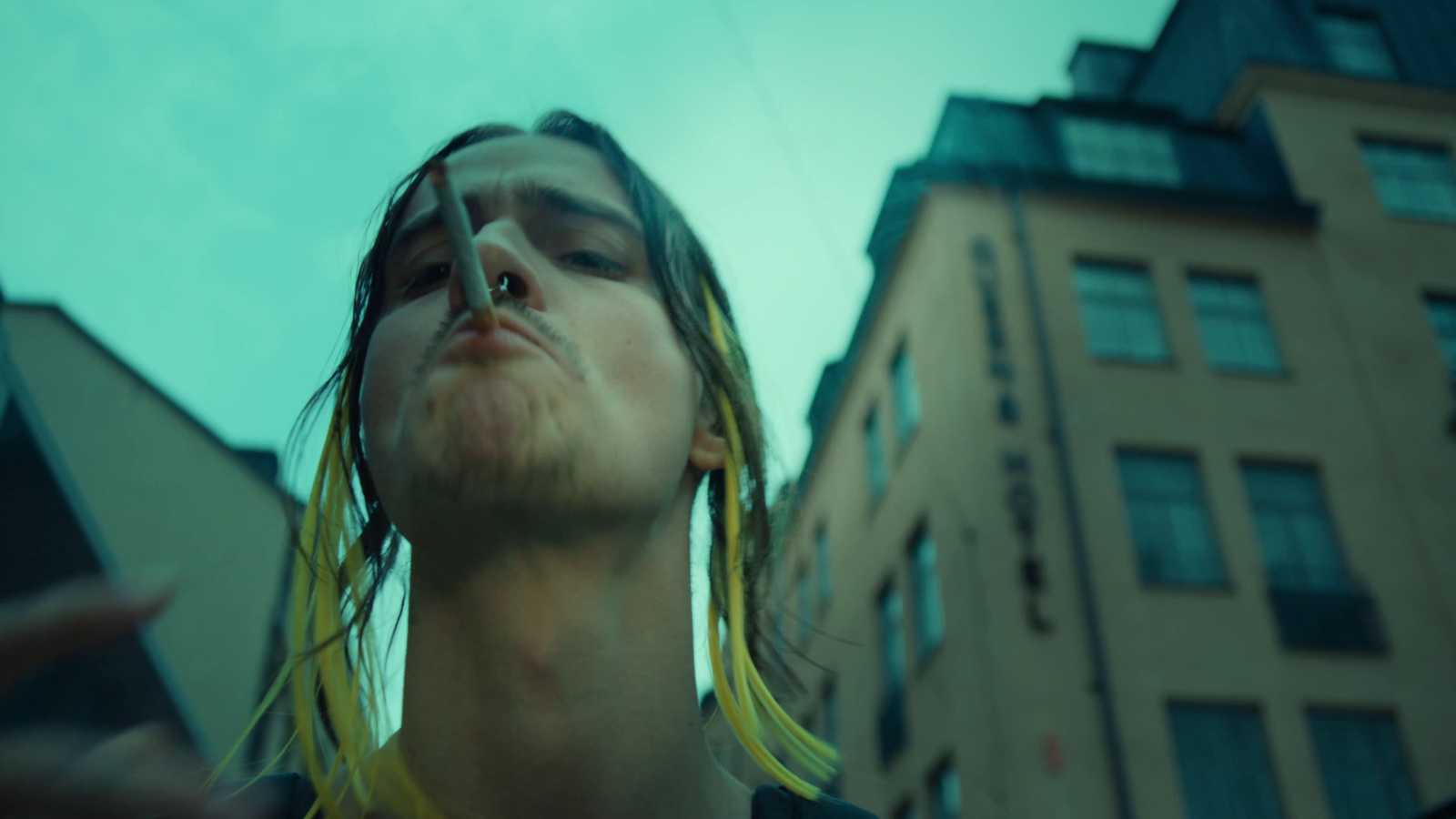 a man with long hair looking up into the sky