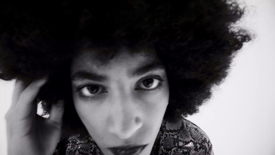 a black and white photo of a woman with an afro