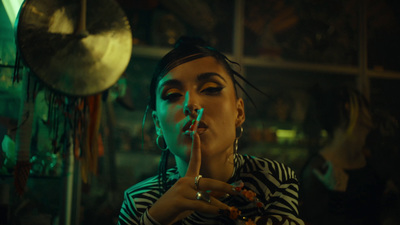 a woman smoking a cigarette in a dark room