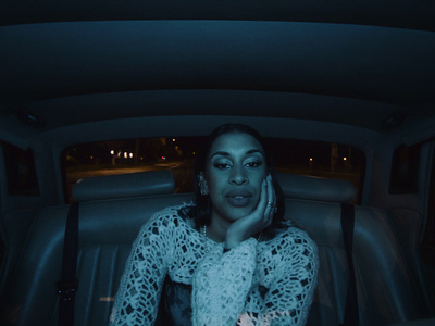 a woman sitting in the back of a car