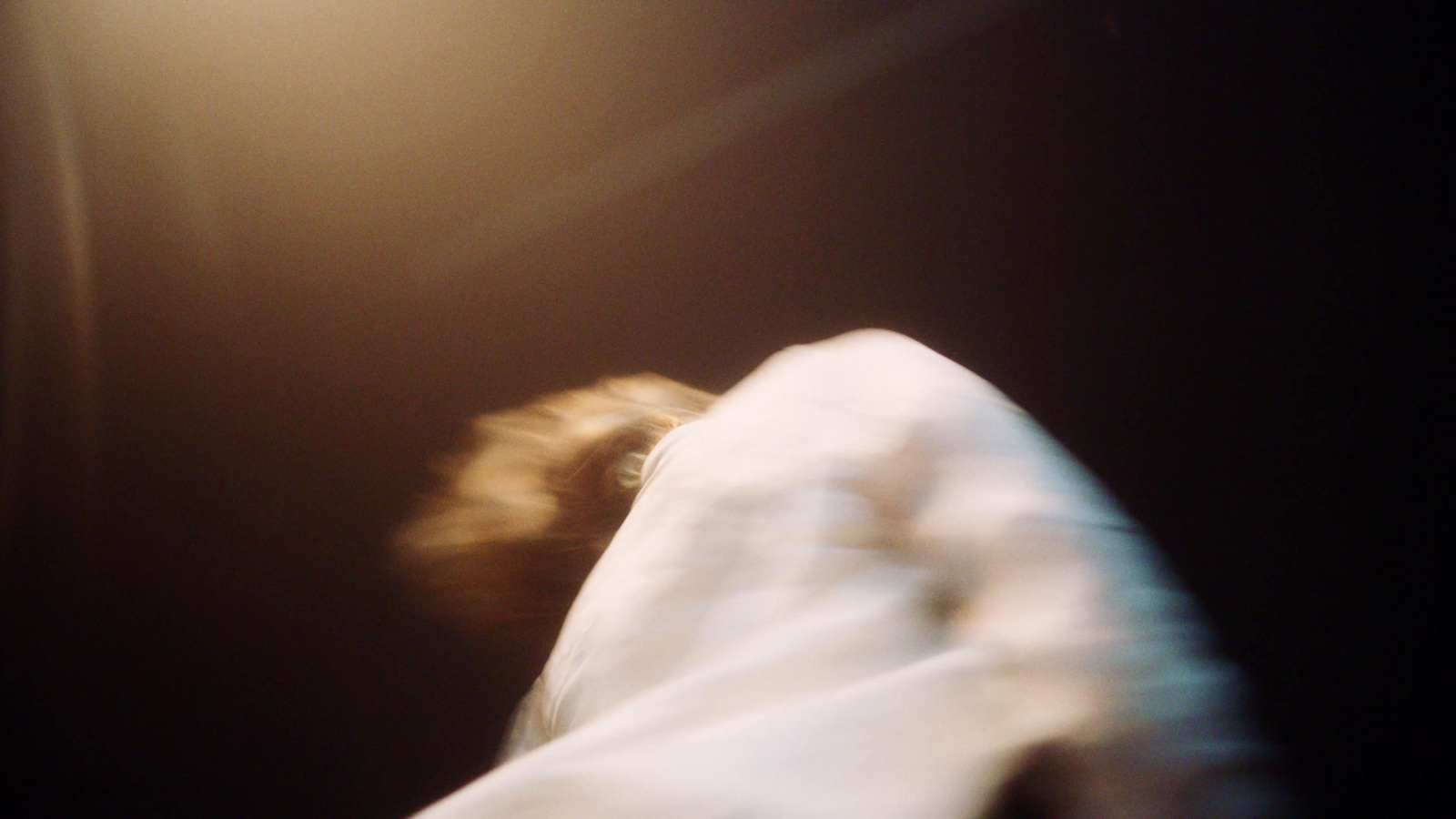 a blurry photo of a person in a white shirt