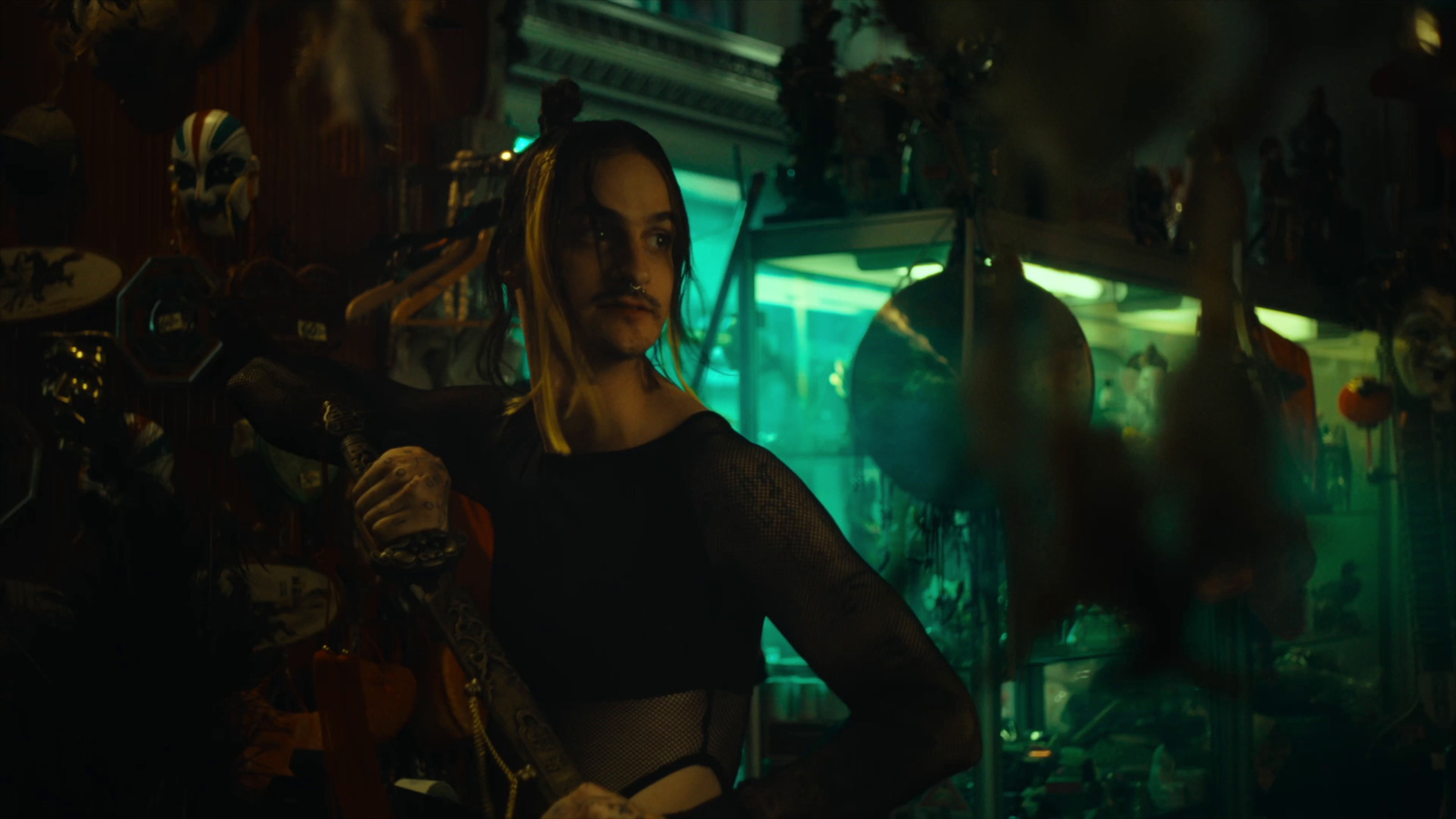 a woman standing in a room holding a guitar