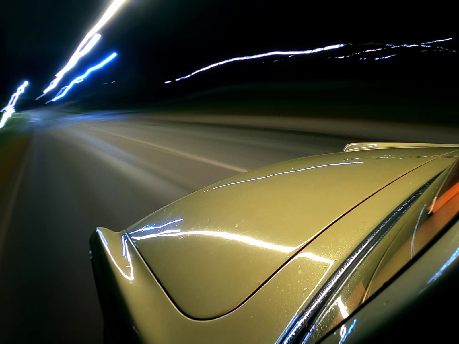 a car driving down a road at night