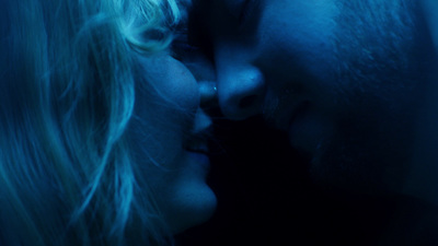 a man and a woman kissing in the dark