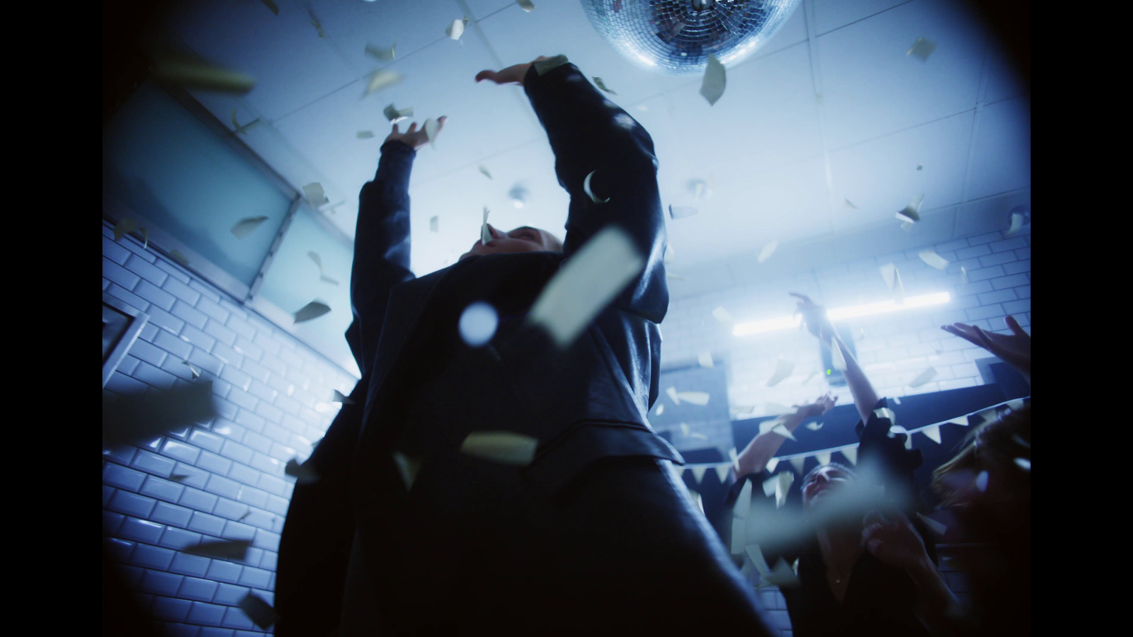 a group of people throwing confetti in the air