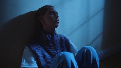 a woman sitting on the floor in a blue room