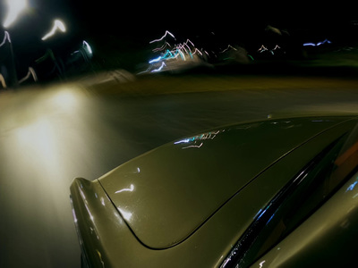 a car driving down a street at night