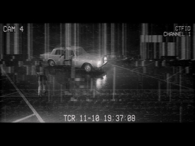 a man standing next to a car in the rain