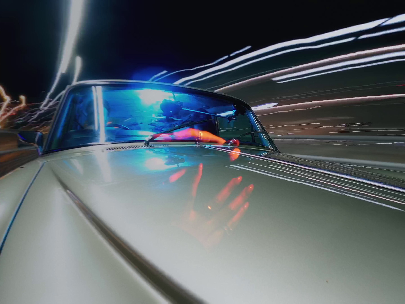 a car driving down a street at night