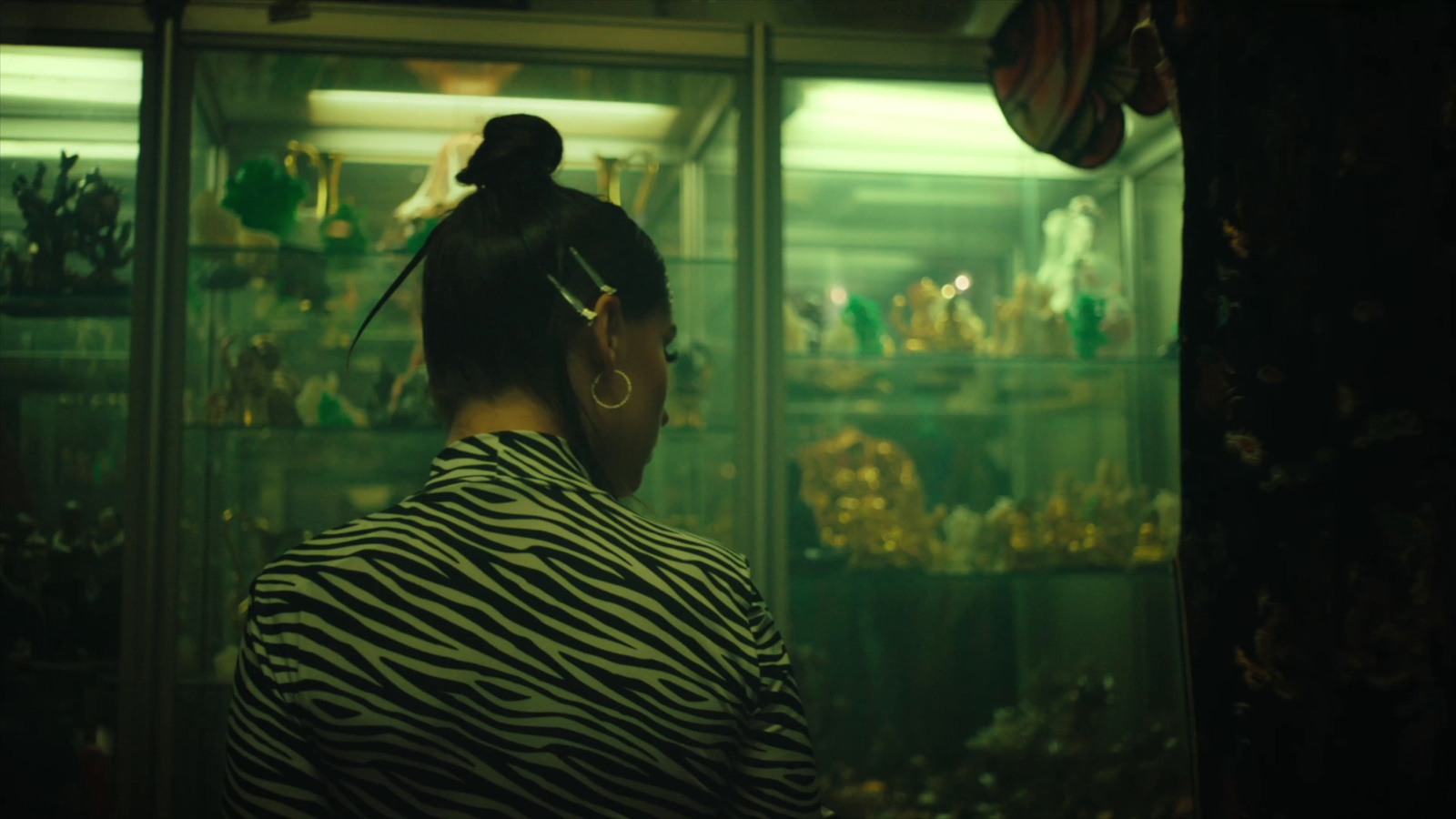 a woman standing in front of a display case