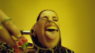 a woman is looking through a magnifying glass