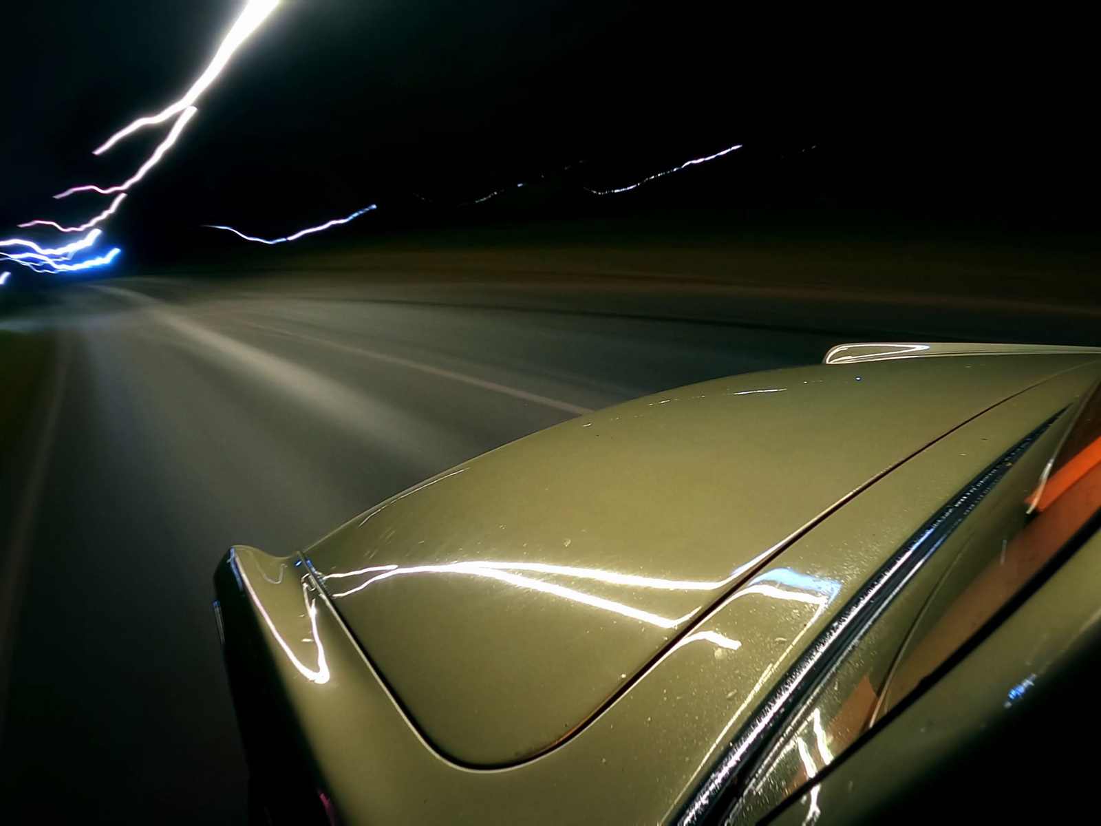 a car driving down a road at night