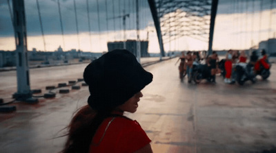 a group of people walking across a bridge