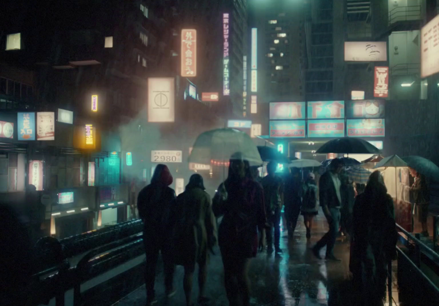 a group of people walking down a street at night