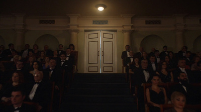 a group of people sitting in chairs in front of a door