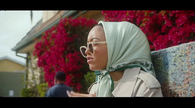 a woman wearing a headscarf and sunglasses