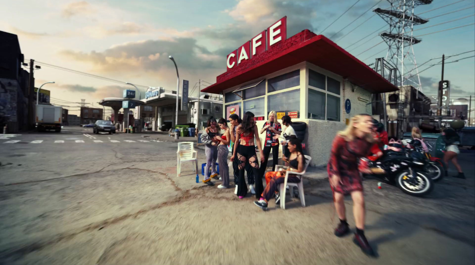 a group of people standing in front of a cafe