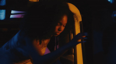 a woman looking at her cell phone in the dark