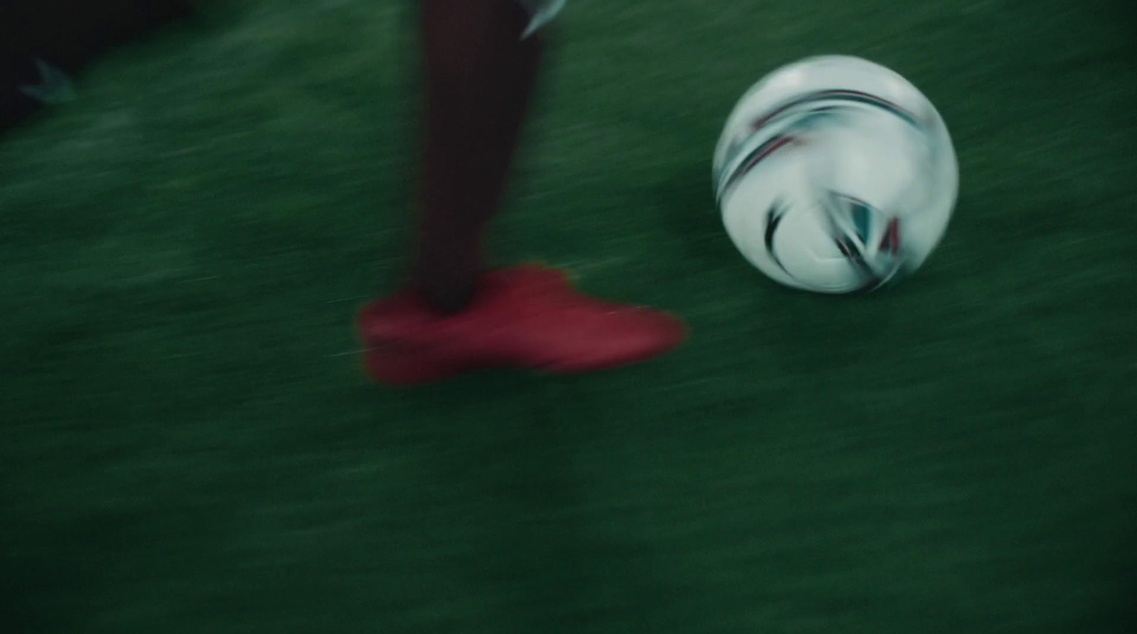 a close up of a person kicking a soccer ball