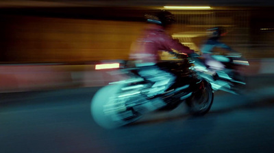 a blurry photo of two people riding motorcycles