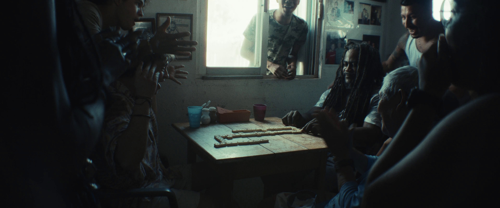 a group of people sitting around a wooden table