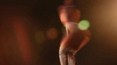 a blurry image of a person standing on a stool