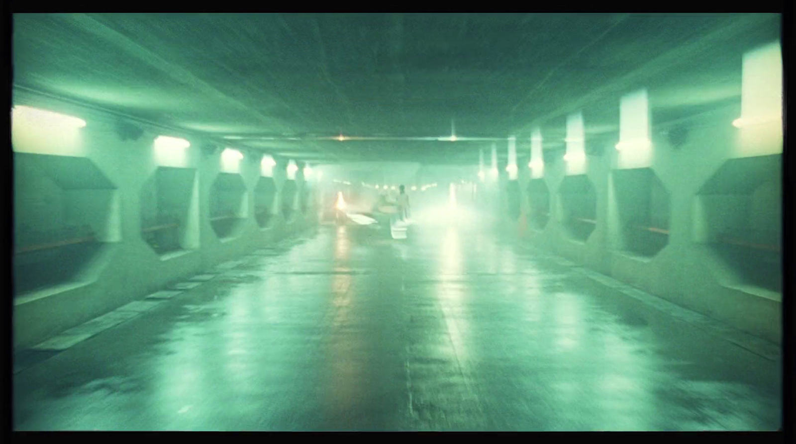 a car driving through a tunnel on a rainy day