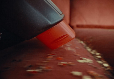 a close up of a person's hand holding a red cup