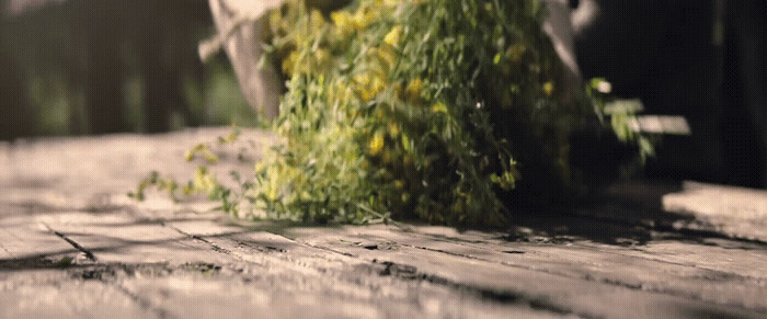 a pile of grass sitting on top of a wooden floor