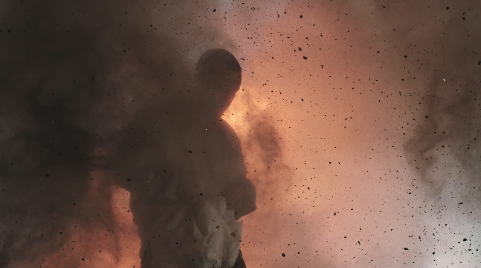 a man standing in front of a cloud of smoke