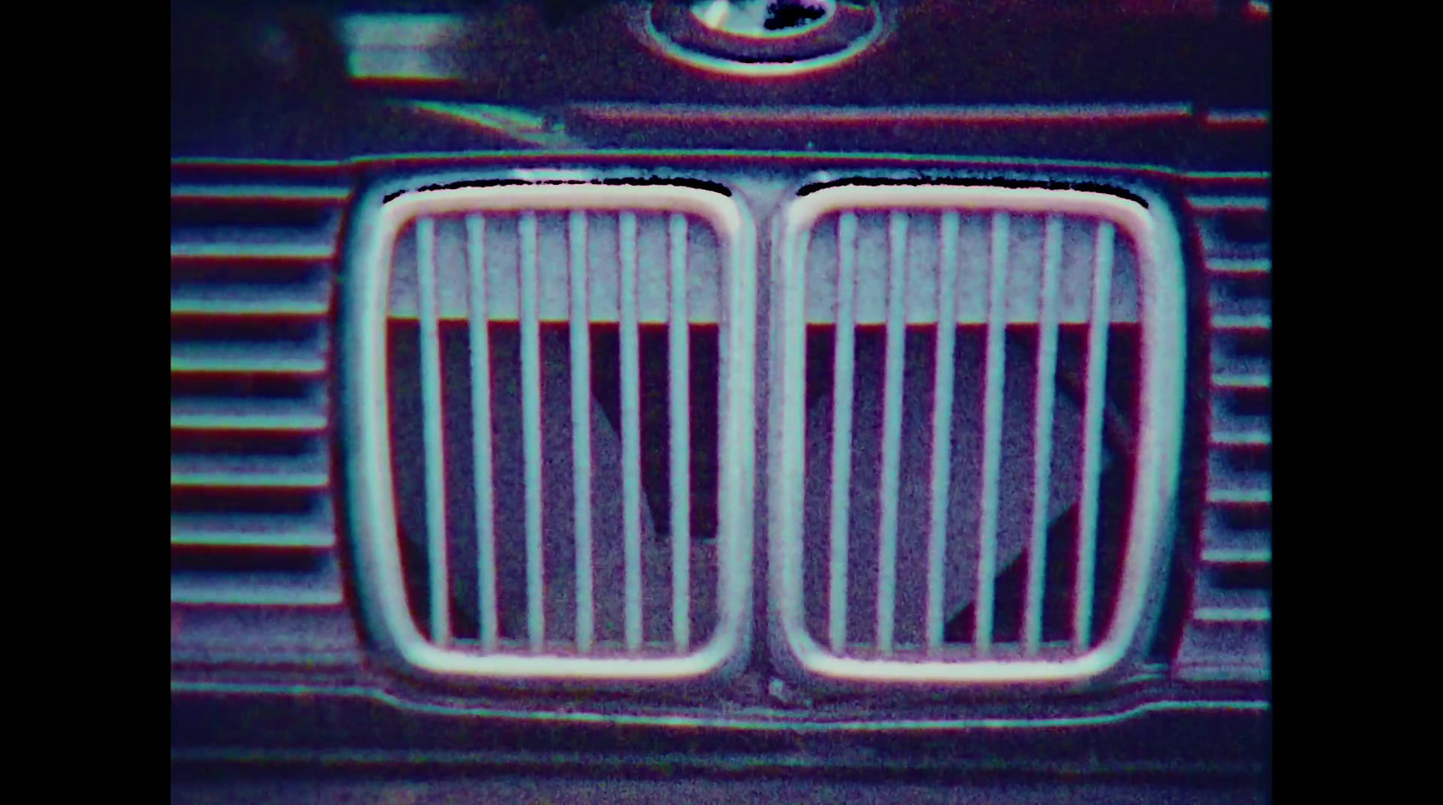 a close up of a grill on a car