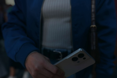 a man in a blue jacket holding a cell phone