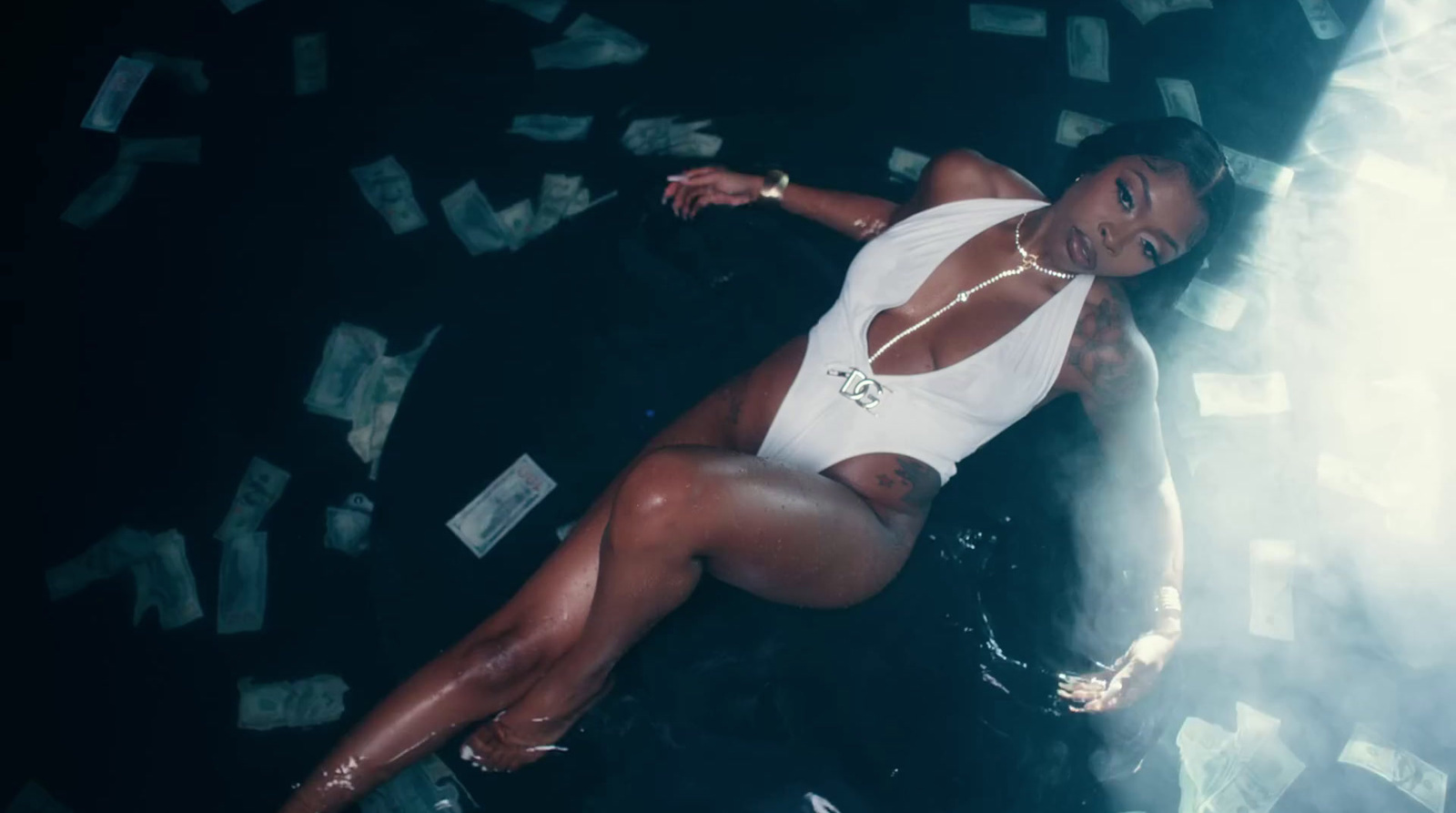 a woman laying on the ground surrounded by money