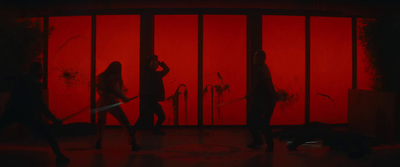 a group of people standing in front of a red wall