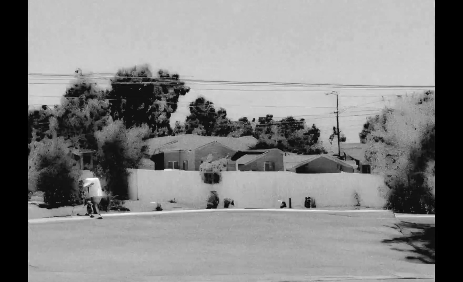 a black and white photo of a person on a skateboard