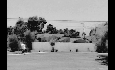 a black and white photo of a person on a skateboard