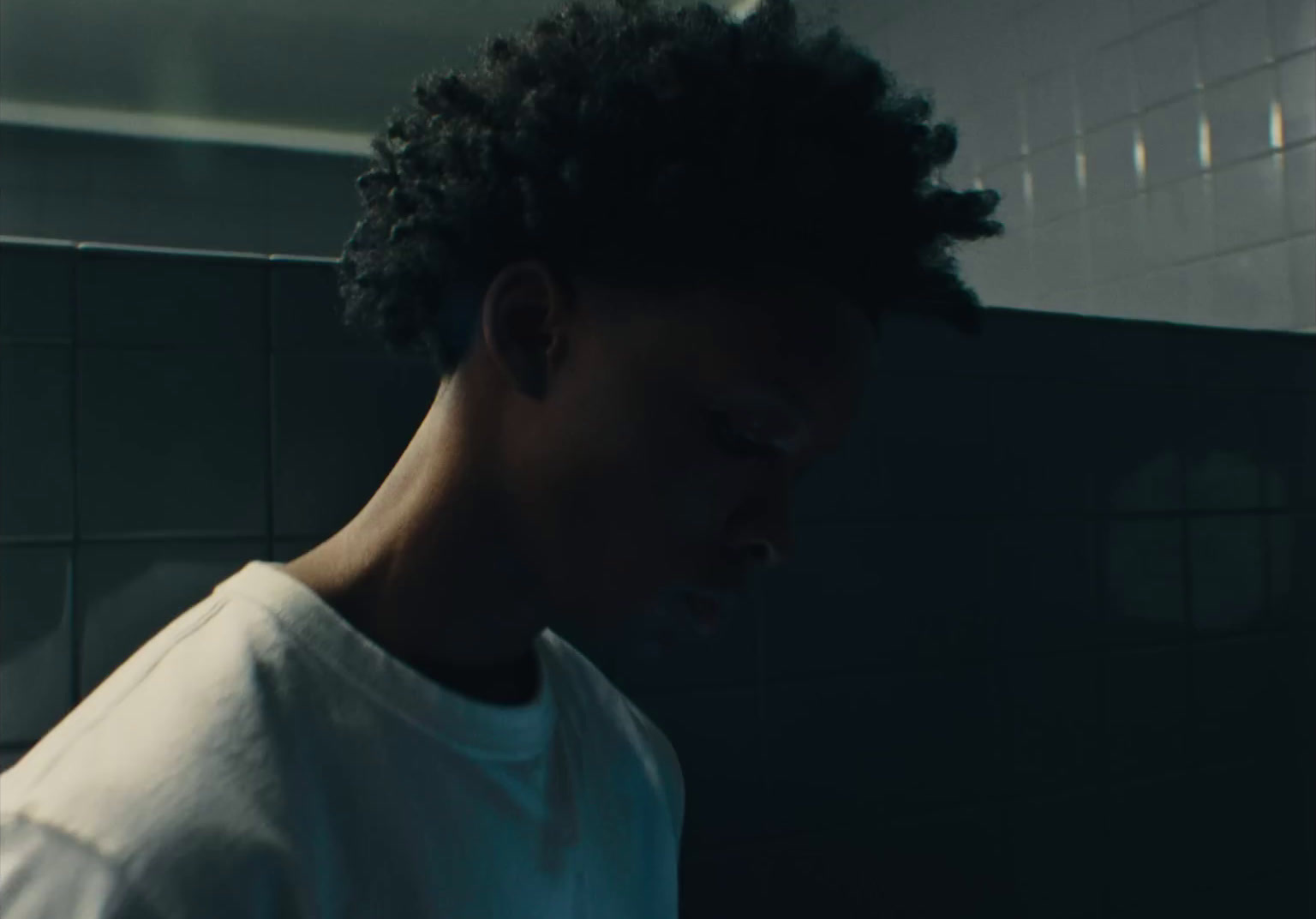 a man in a white shirt in a bathroom