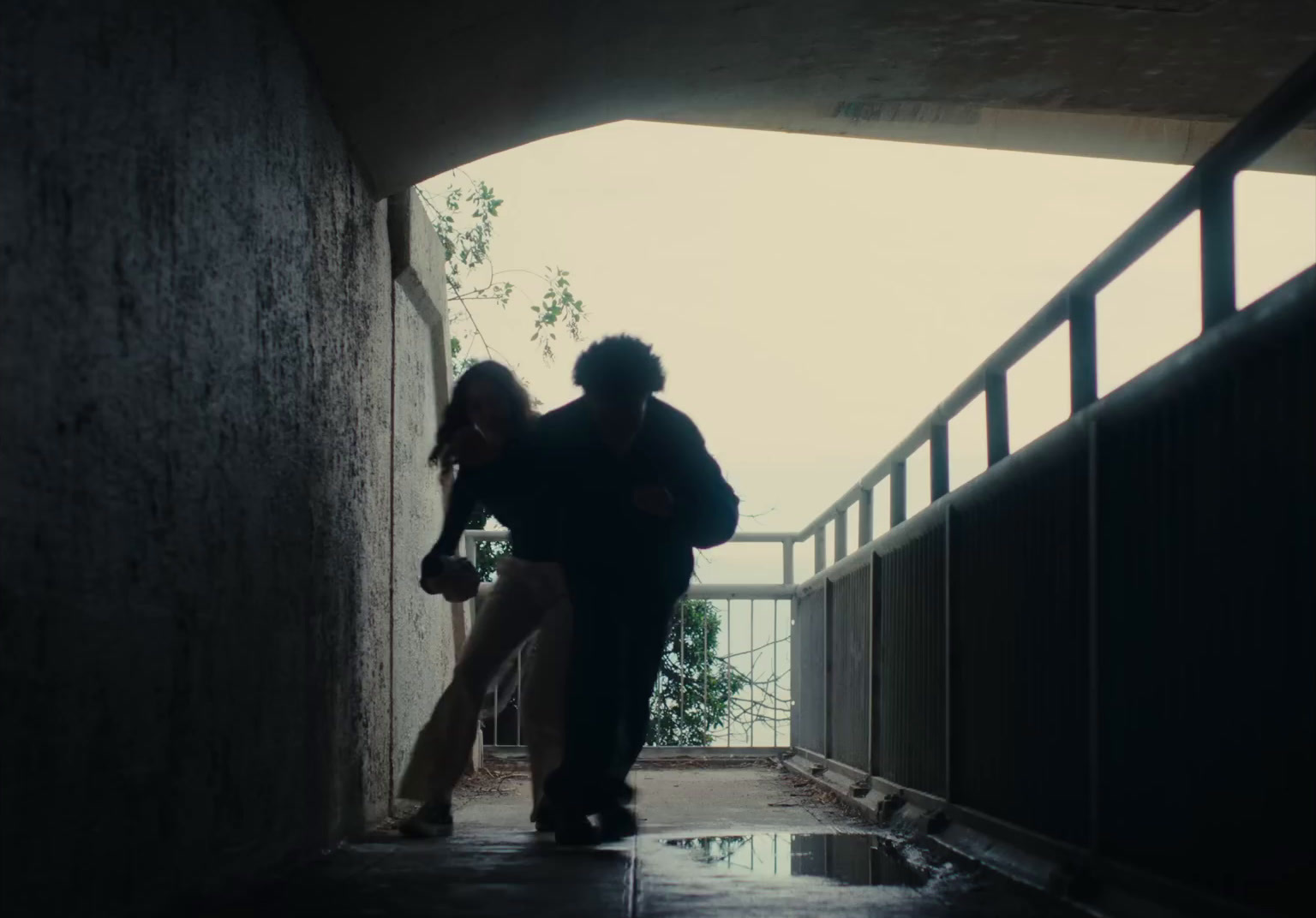 a couple of people walking down a hallway