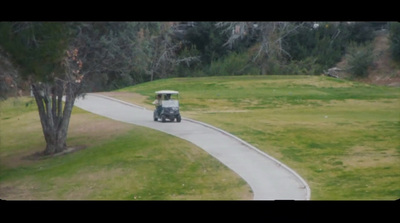 a golf cart driving down a winding road