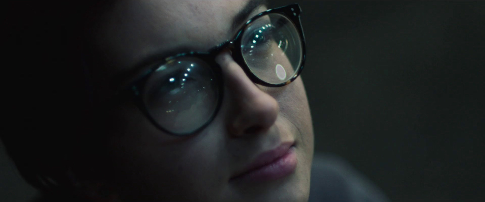 a close up of a person wearing glasses