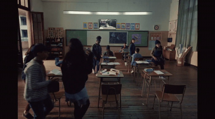 a group of people standing around a classroom