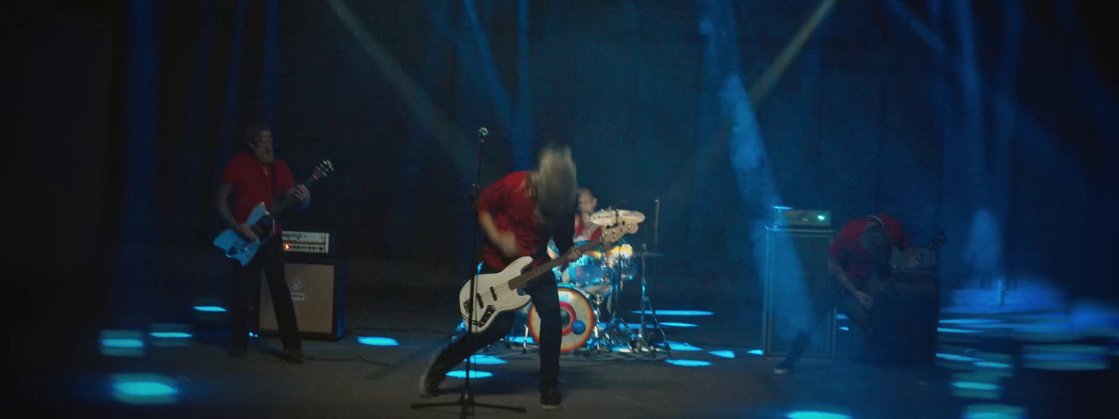 a group of people on stage with guitars