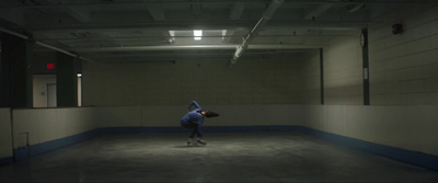 a man riding a skateboard down a cement floor