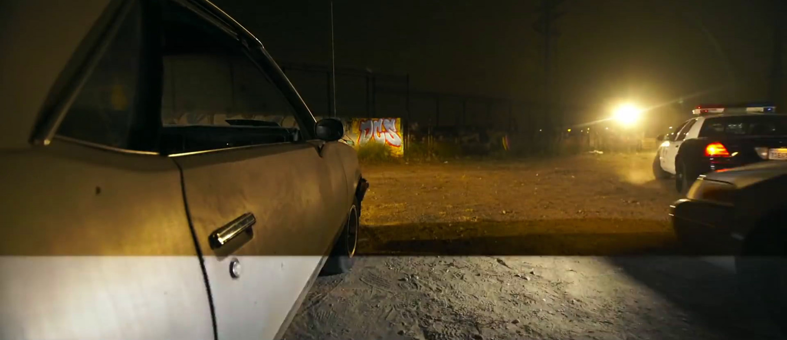 a couple of cars that are sitting in the dirt