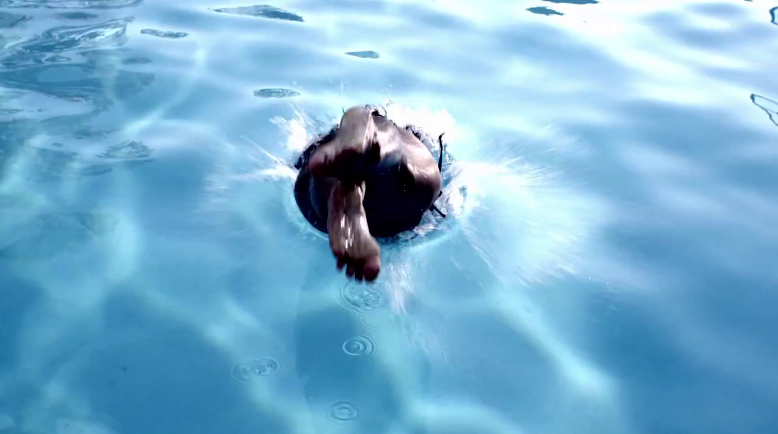 a person floating in a pool of water