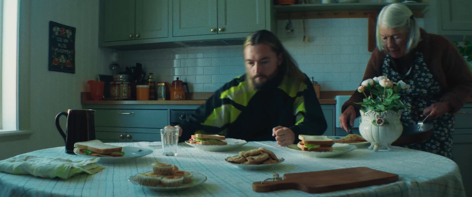 a man and woman sitting at a table with plates of food